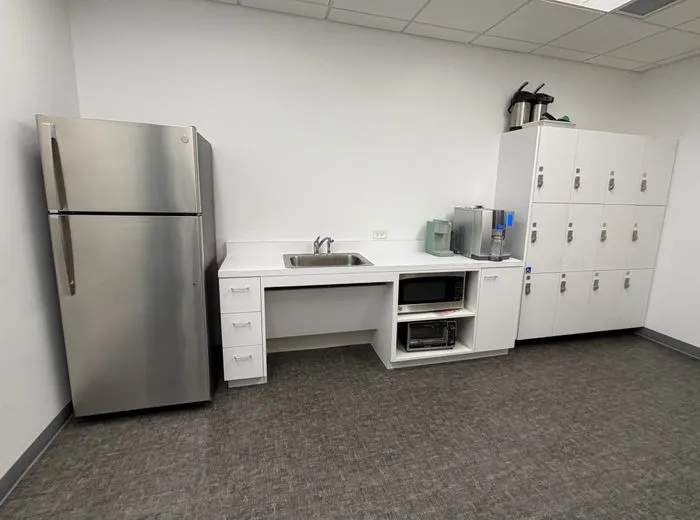 Clean office breakroom with wiped counters and appliances