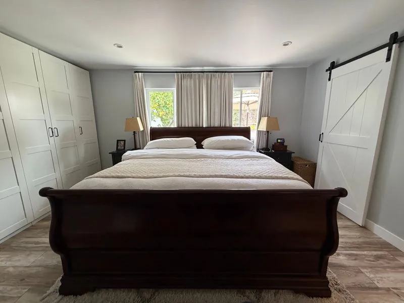 Calm bedroom with a freshly made sleigh bed