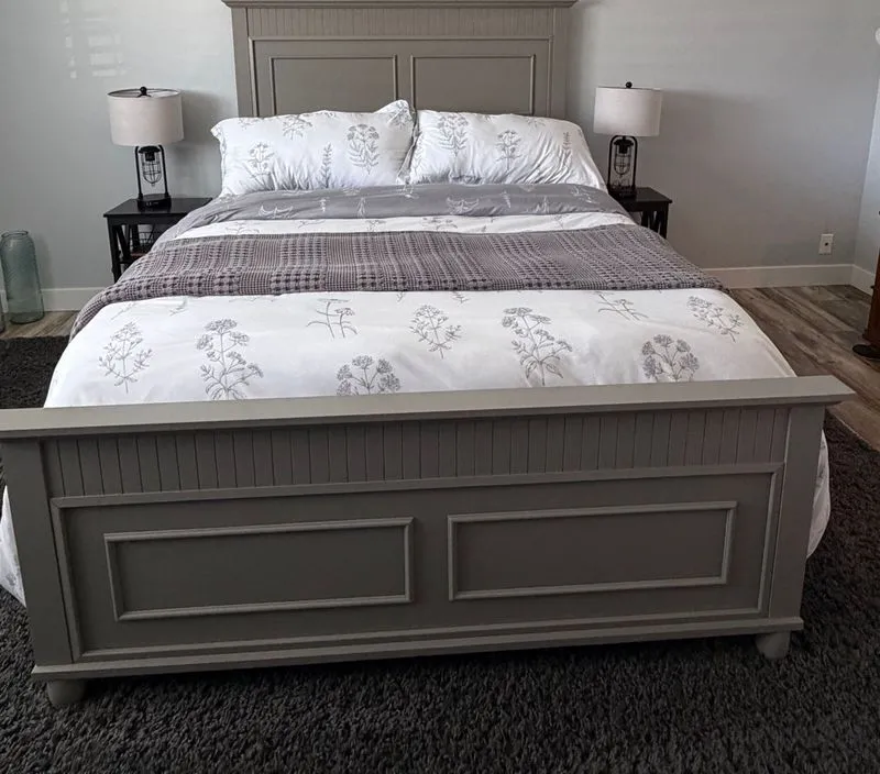 Tidy grey bedroom with a made bed