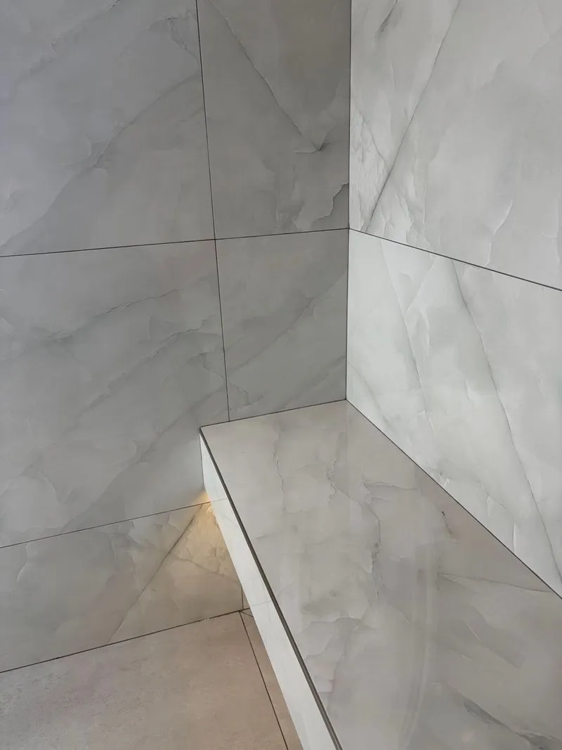 Marble-look shower bench and walls after cleaning