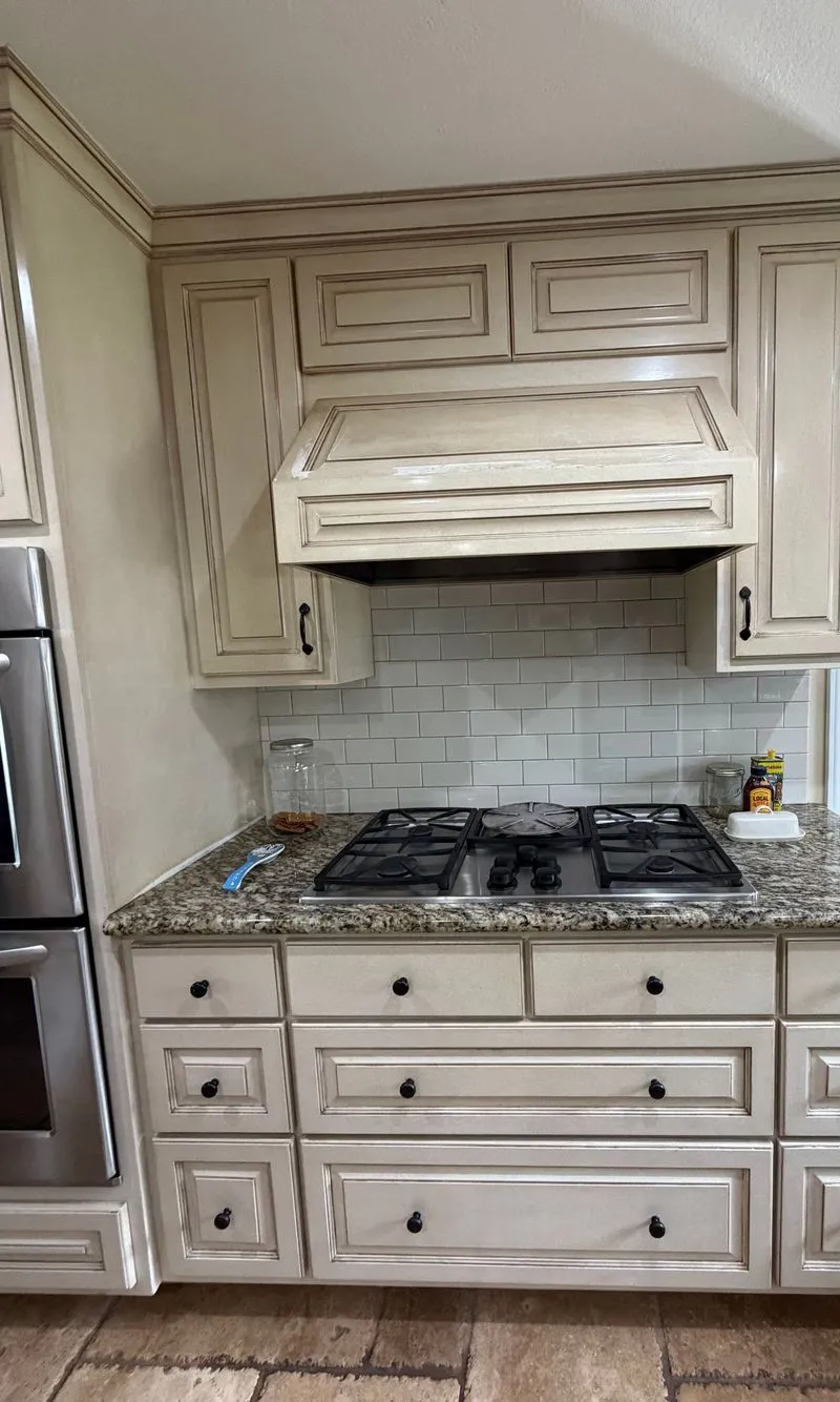 Kitchen range hood and cream cabinets, wiped clean