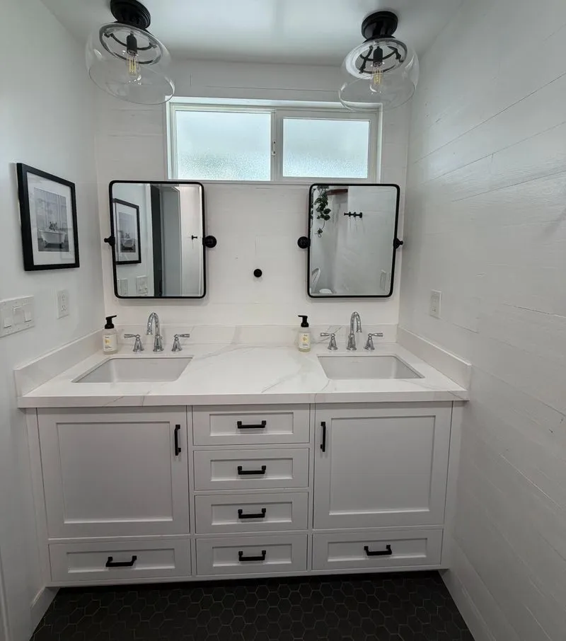 Bright double vanity bathroom with clean mirrors and counters
