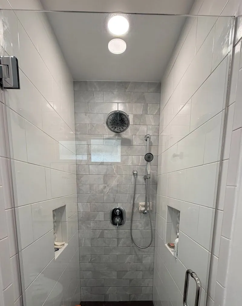 Walk-in shower with white tile after cleaning